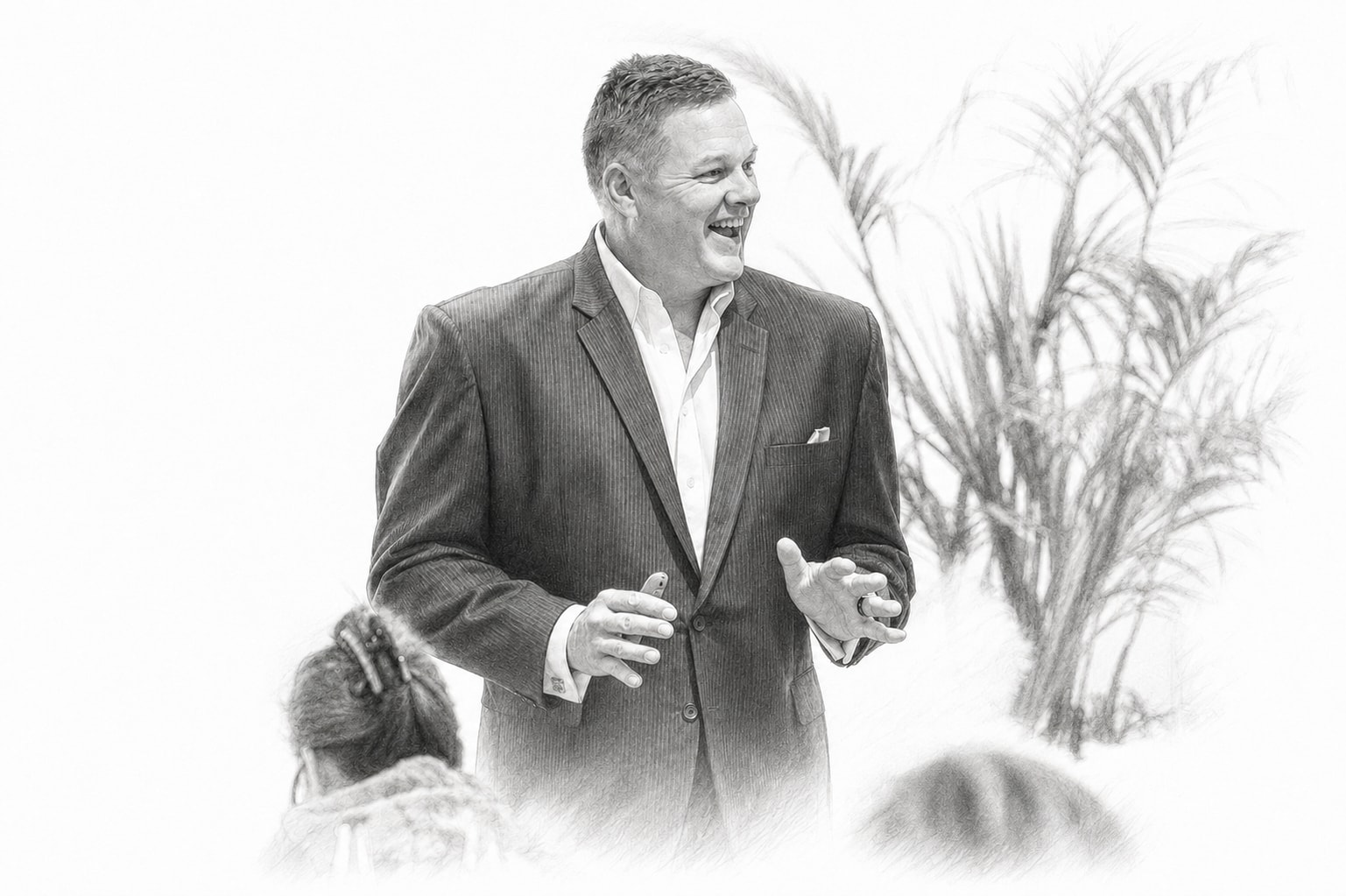 Chris laughing while speaking with a small seated audience